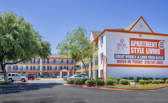 Siegel-Select-Suite-Front entrance with white and orange buildings